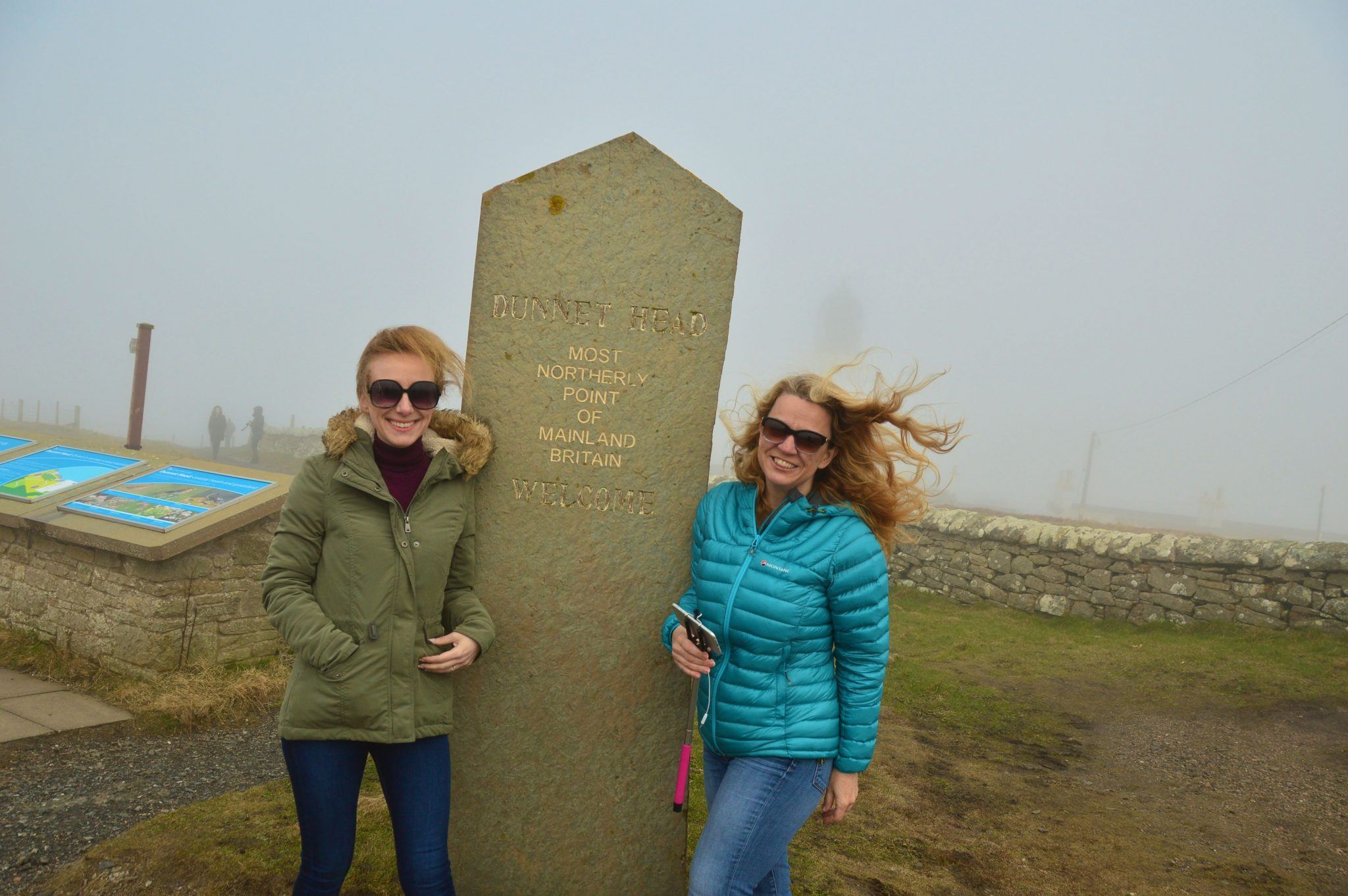 two women at sign for the northern most point of the united kingdom