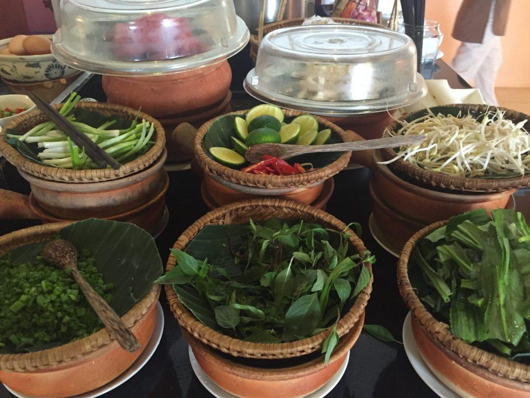 bowls of herbs and fruits on a breakfast buffet hoi an blog