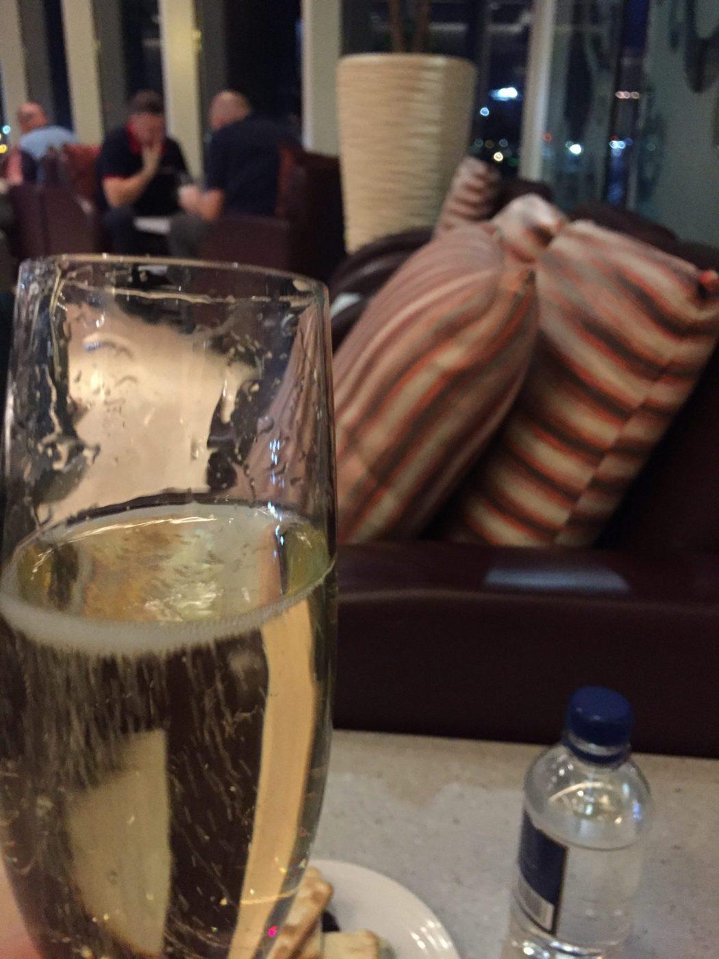 glass of champagne in lounge at heathrow terminal 4 for malaysia airlines business class