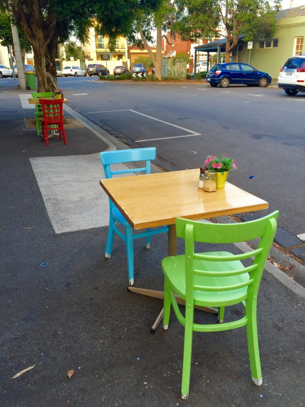 6 Best Brunch Places Melbourne 5 colourful chairs with wooden tables on the street at My Sista Says Port Melbourne