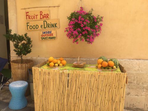 rustic signs above a table with fruit and a hanging basket noto sicily rustic signs above a table with fruit and a hanging basket noto sicily