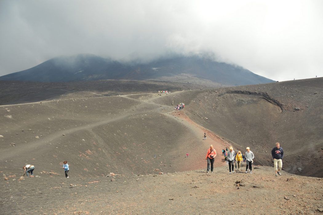 Sisilian Etna-vuoren huipulla kävelevät ihmiset