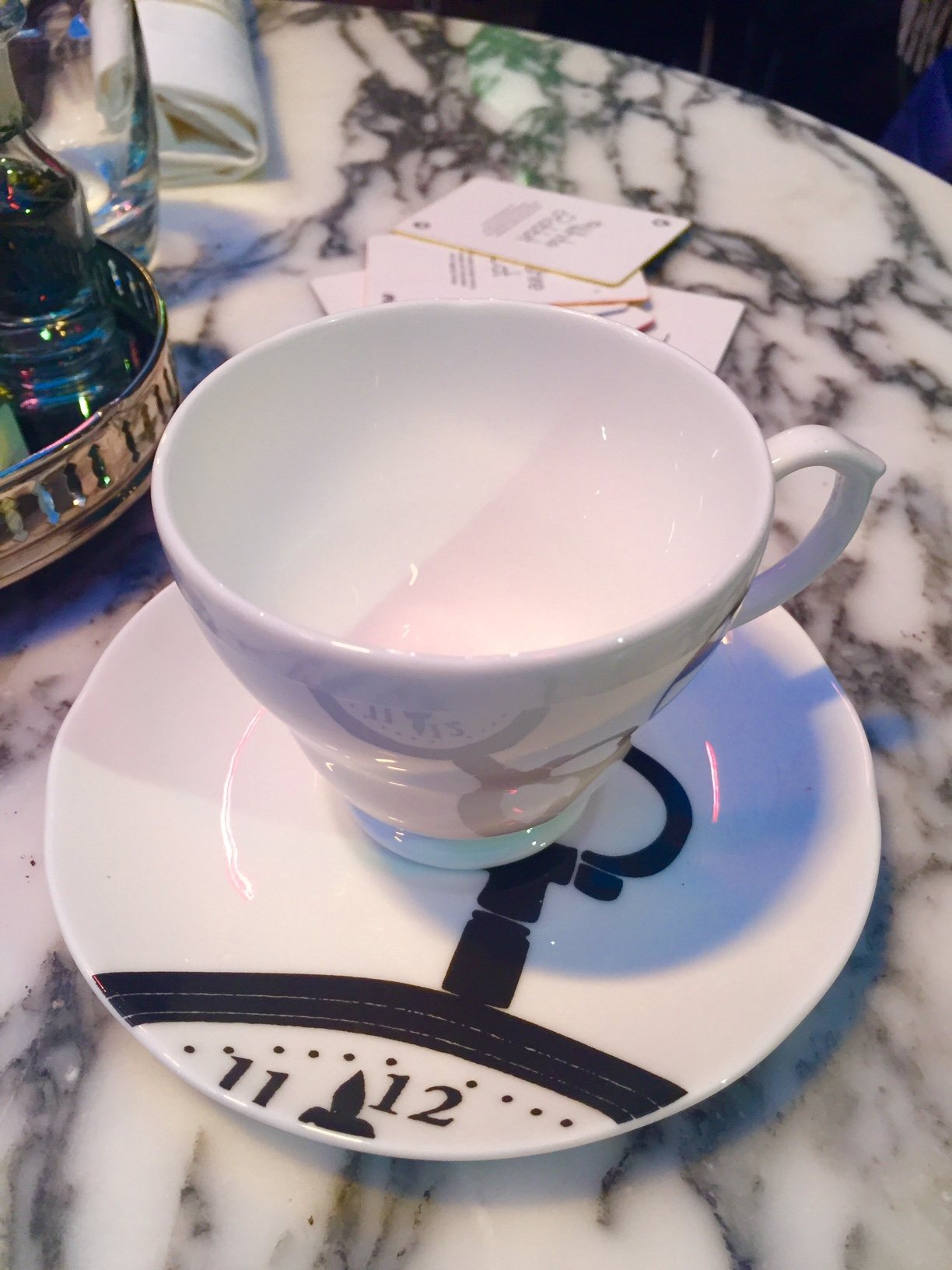 Mad Hatters Afternoon Tea London: The most fun you can have at afternoon tea 2 white cup and saucer with time graphic