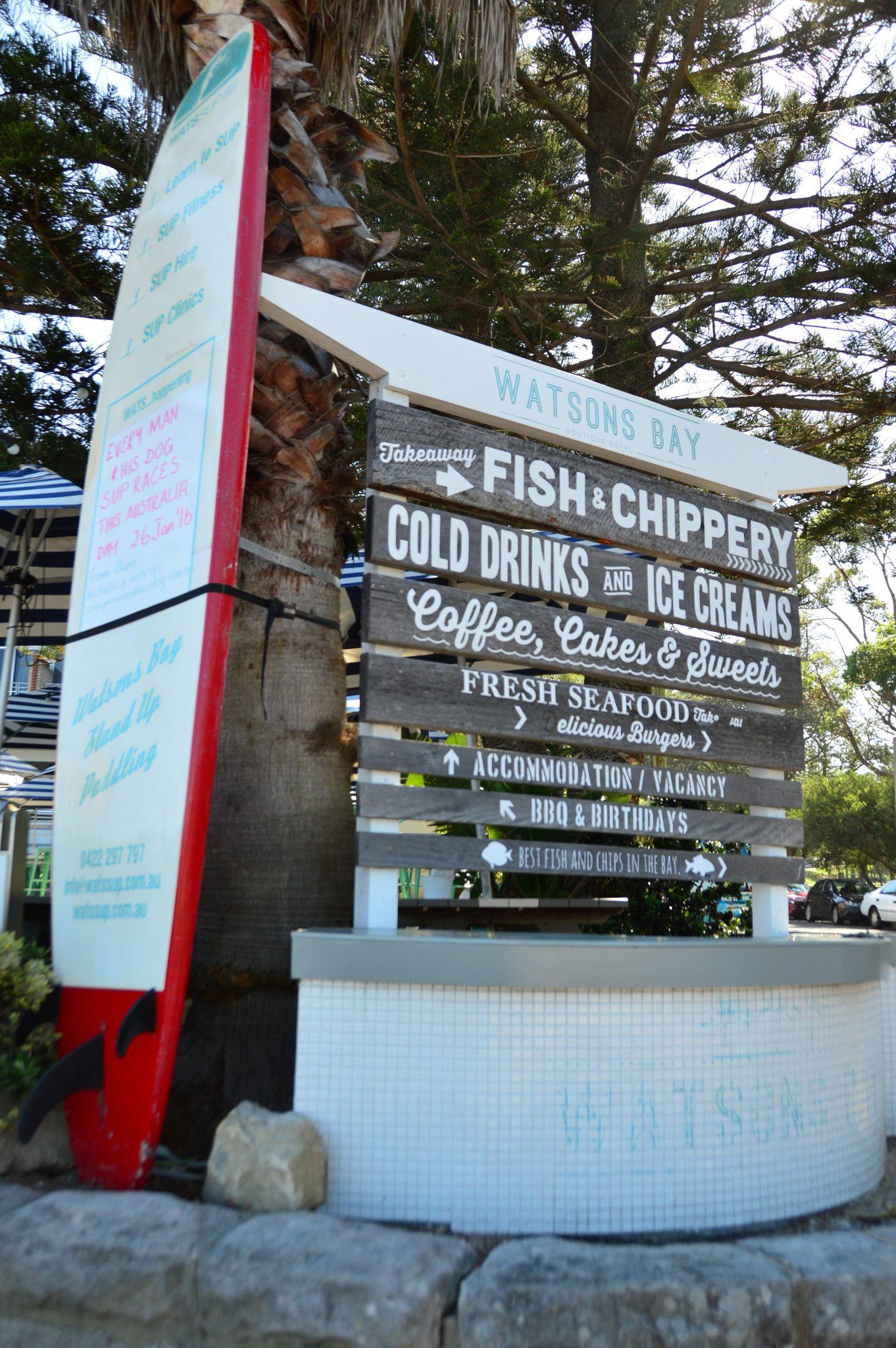 multiple signs with food and drinks at watsons bay sydney