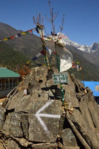 sign saying way to mt everest on a stack with prayer flags nepal sign saying way to mt everest on a stack with prayer flags nepal
