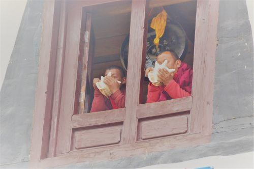 2 monks at window blowing into shells tengboche nepal 2 monks at window blowing into shells tengboche nepal
