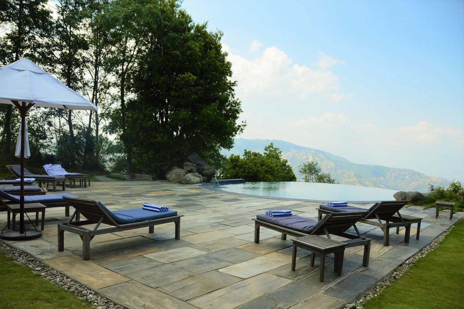 infinity pool with lounges at dwarika's resort dhulikhel