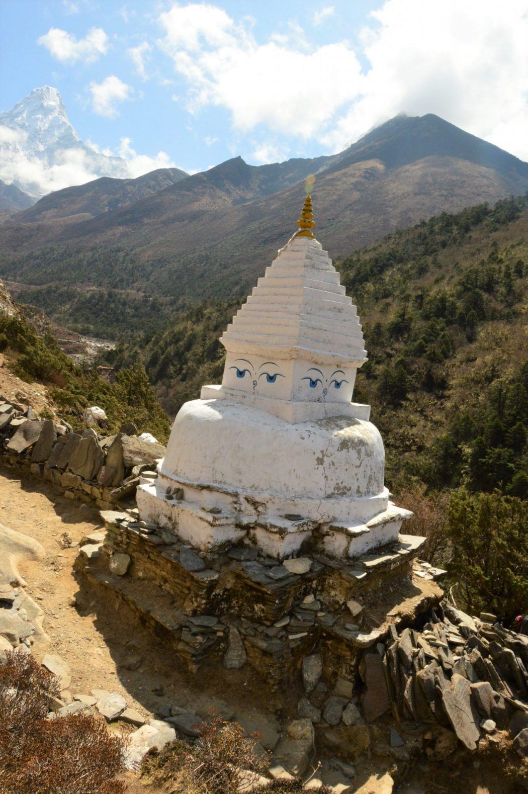 white stupa on everest base camp trek with mountains in background