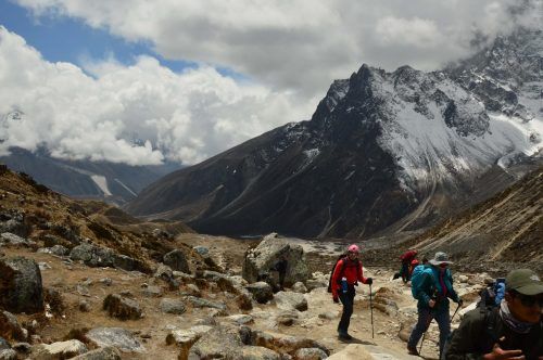 trekkers with mountains and clouds behind them in nepal trekkers with mountains and clouds behind them in nepal