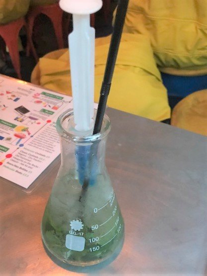 cocktail in a beaker with a syringe