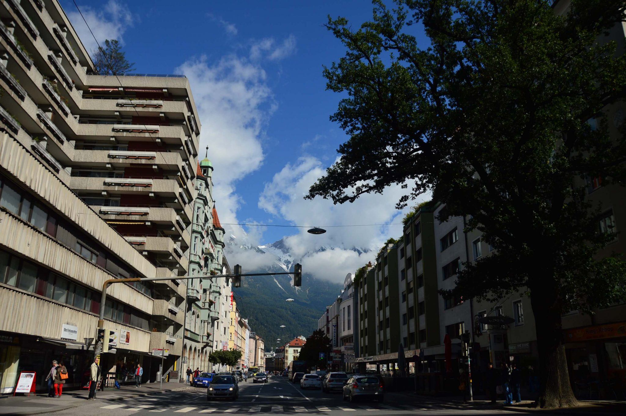 Innsbruck Highlights: What to do on an Innsbruck Layover 1 city street with buildings and mountains in the background innsbruck