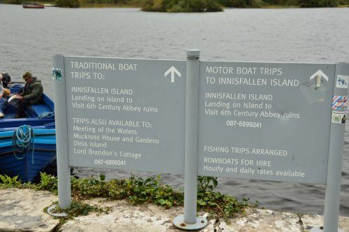 signs with boat trip options for the lake in front of ross castle killarney ireland signs with boat trip options for the lake in front of ross castle killarney ireland