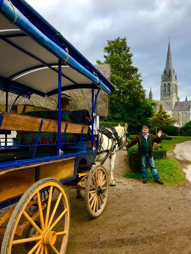 jaunting cart with friendly driver and church in background killarney ireland jaunting cart with friendly driver and church in background killarney ireland
