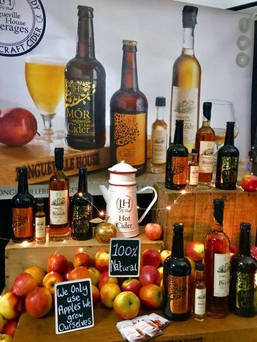 bottles of apple cider and apples bottles of apple cider and apples