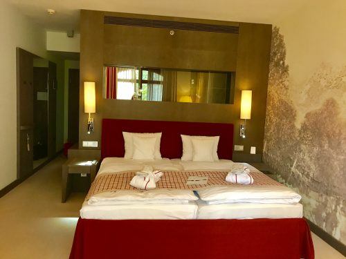 king sized bed in room at arosa kitzbuhel