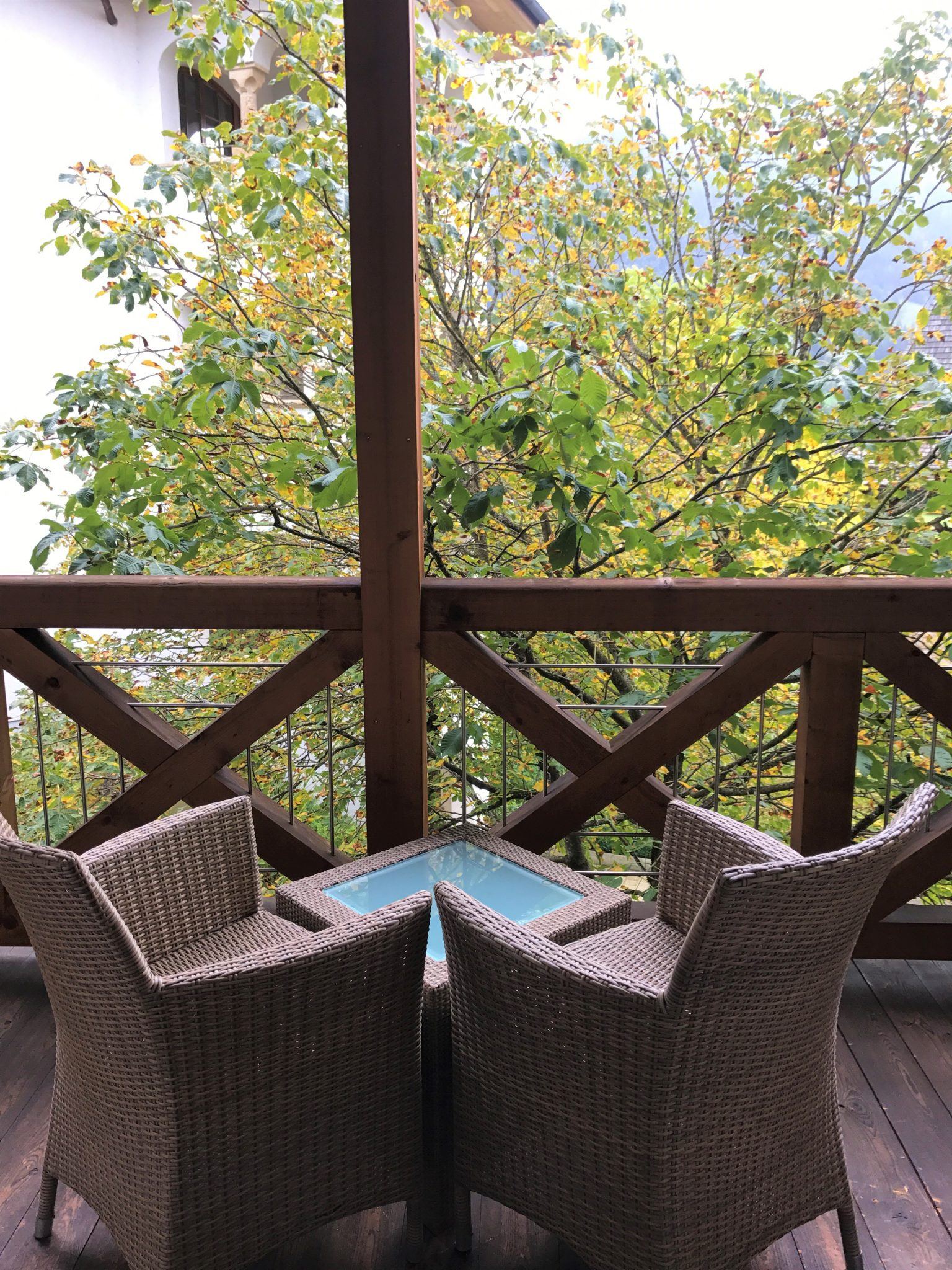 Hotel Arosa Kitzbühel Austria Boutique Hotel Review 5 rattan chairs with table on terrace at Arosa Kitzbühel