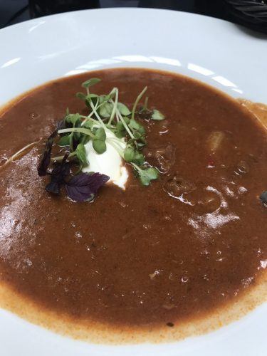 goulash soup in a bowl with cream on top Arosa Kitzbühel goulash soup in a bowl with cream on top Arosa Kitzbühel