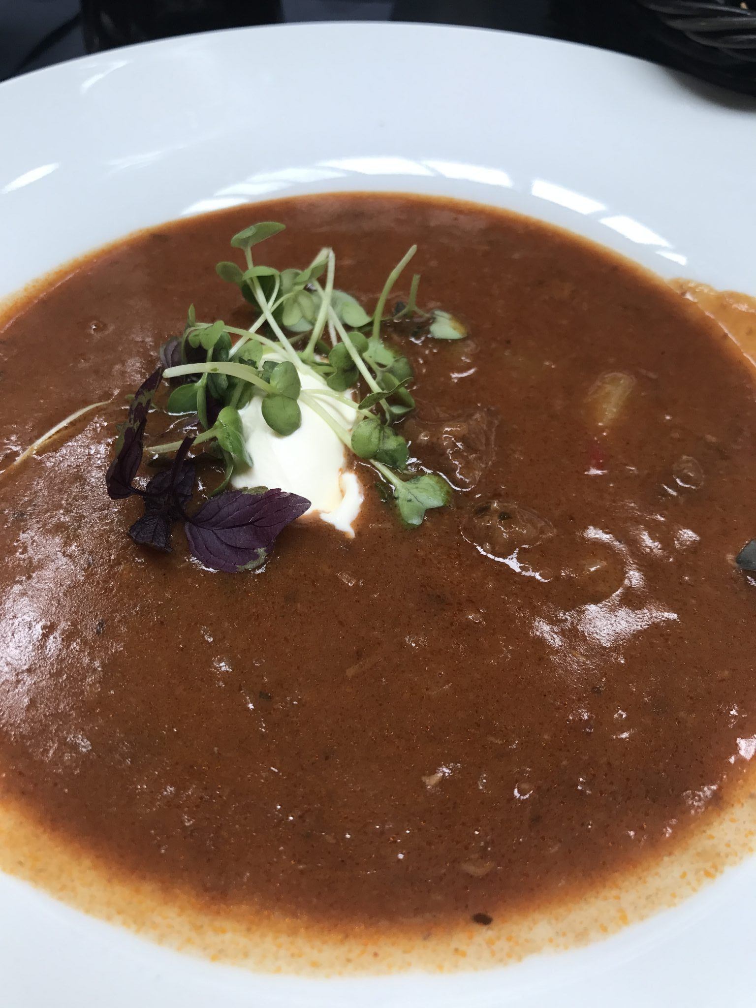 goulash soup in a bowl with cream on top Arosa Kitzbühel
