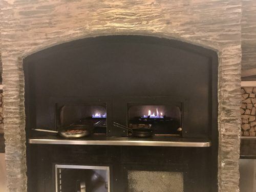 open oven and fry pans in kitchen at Arosa Kitzbühel open oven and fry pans in kitchen at Arosa Kitzbühel