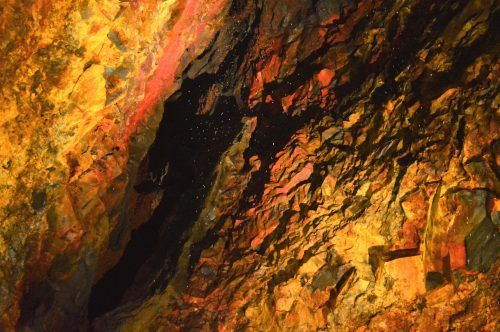 light snowfall against coloured rock walls inside the volcano iceland