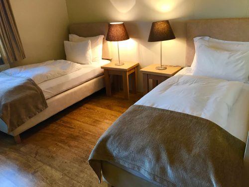 twin beds and lamps room at northern lights inn iceland