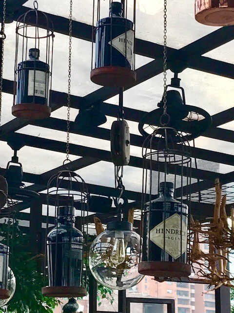 gin bottles in light fittings art hotel medellin
