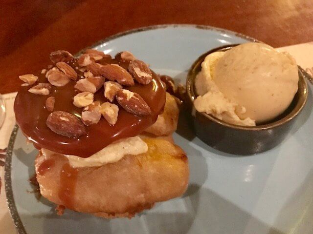 dessert with caramel sauce and ice cream on the side at Oci Medellin