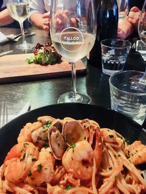 pasta with seafood and a glass of wine at Italicos Sorrento