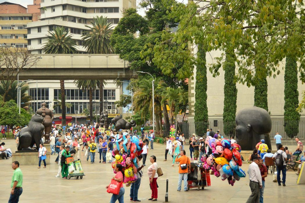 people and sculptures in plaza botero medellin