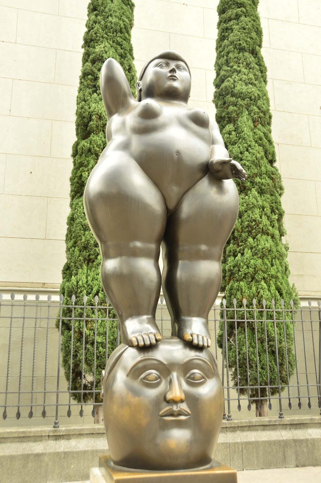 botero sculputre of naked woman standing on head