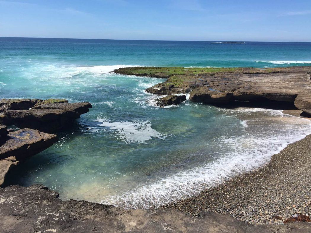 10 Best Weekend Getaways From Sydney for Boutique Hotel Lovers 32 ocean water against rocks with moss on the australia east coastline