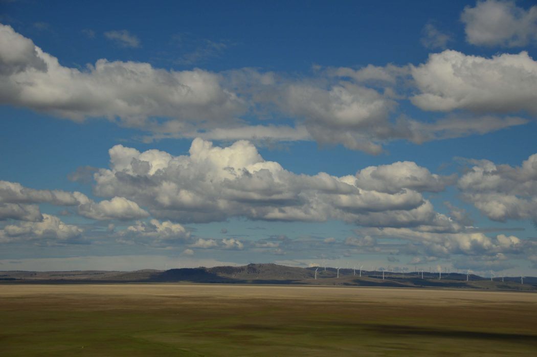 10 Best Weekend Getaways From Sydney for Boutique Hotel Lovers 34 long distance view of wind farms with big sky and clouds in australia
