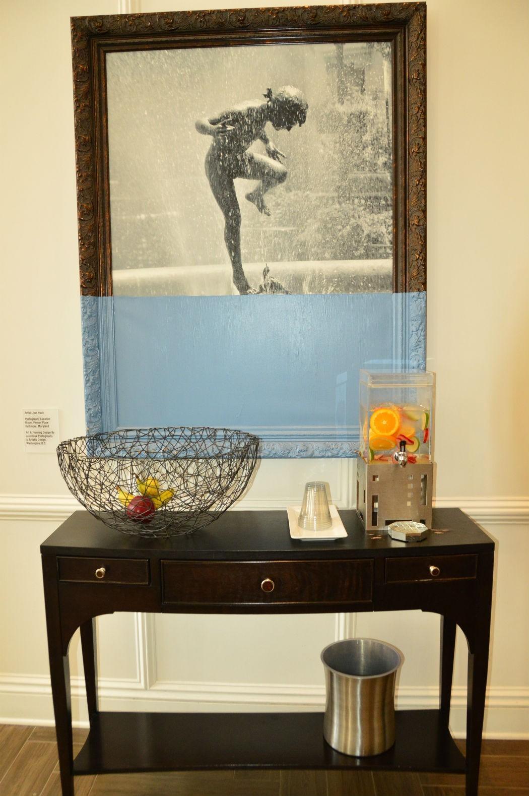 framed picture in front of table with water stand at hotel indigo