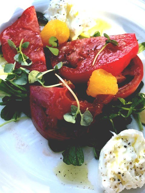 tomatoes with white cheese and greens