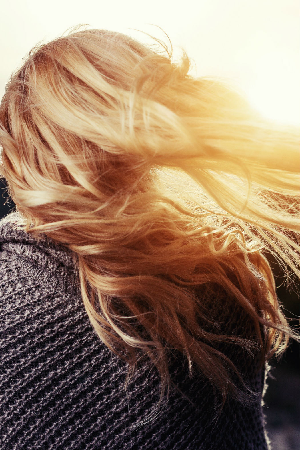 blond woman with hair moving in the light