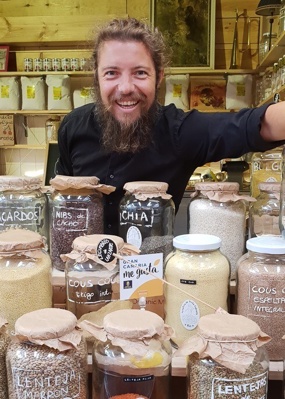 7 Best Gran Canaria Markets You Won't Want to Miss 16 bearded man with glass jars of spices in a market