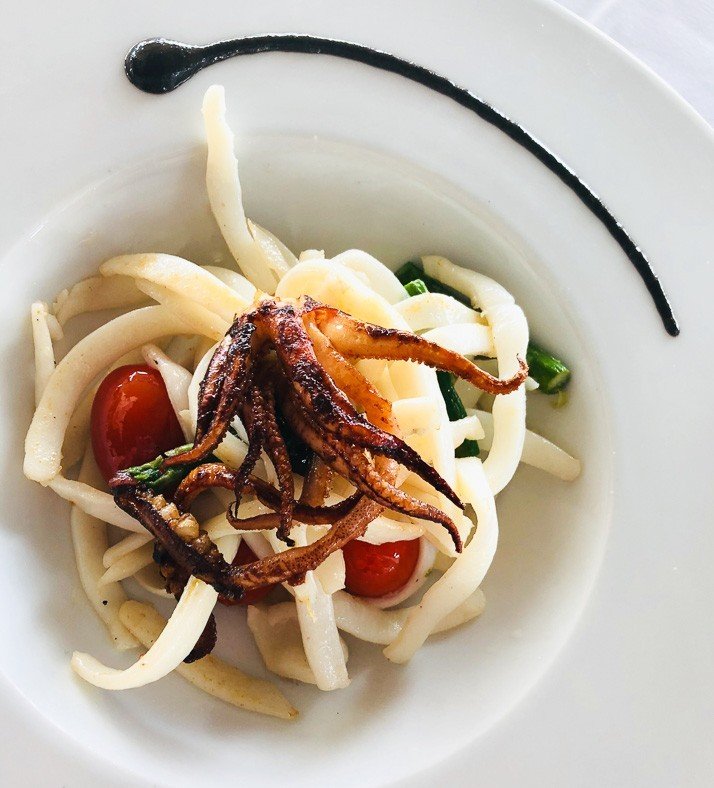 8 Best Things to do in Maspalomas 5 Grilled calamari on a white plate