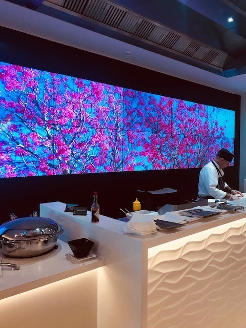 Food preparation station with big screen at the Air new zealand lounge sydney airport