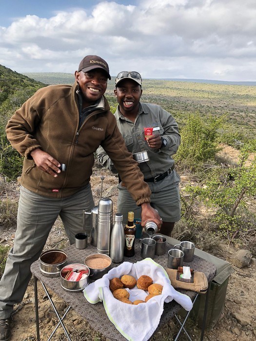 two safari guides at kwandwe with a table and coffee and food