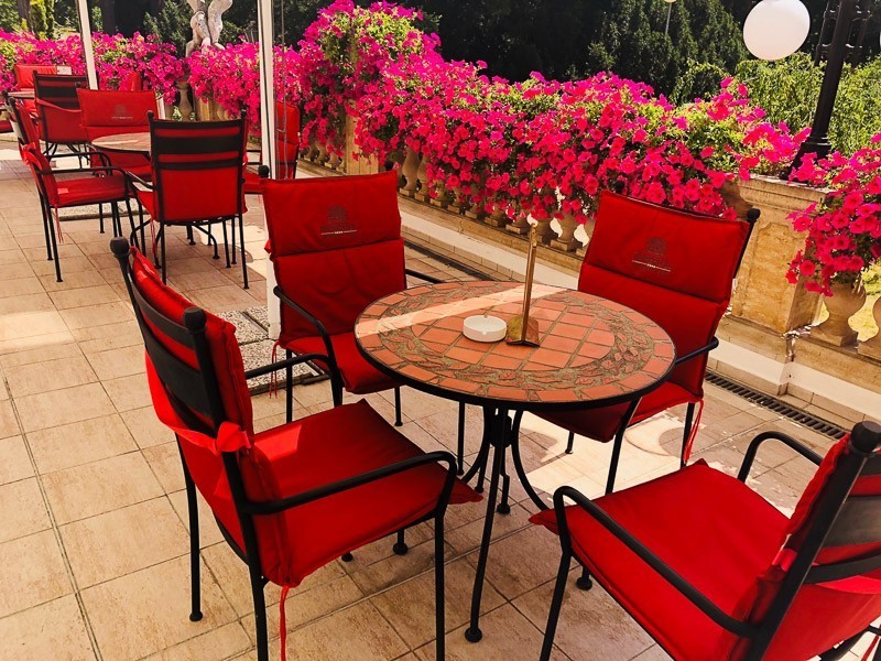 3 Best Czech Republic Spa Towns in Bohemia 34 outside tables with red chairs at Hotel Imperial Frantiskovy Lazne
