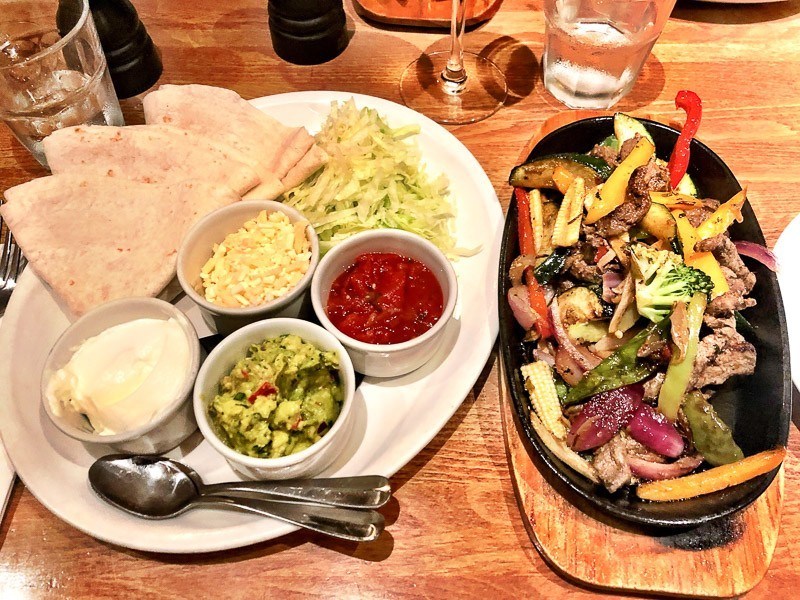 6 Cafes in Exeter Not to Miss 26 chicken fajitas on a table at Harry's Exeter