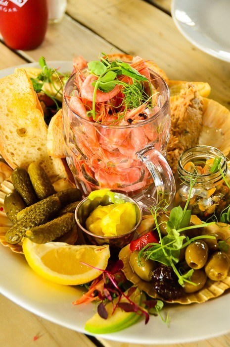 4 Best Things to do in Exmouth You Won't Want to Miss 16 prawns in a glass mug with bread, lemon, olives and more