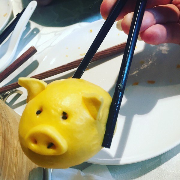 Hong Kong Travel Blog: Heading Off the Beaten Path 6 hong kong dumpling shaped like pig held between chopsticks