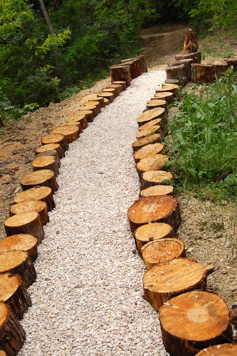 pebbled path trimmed by small logs
