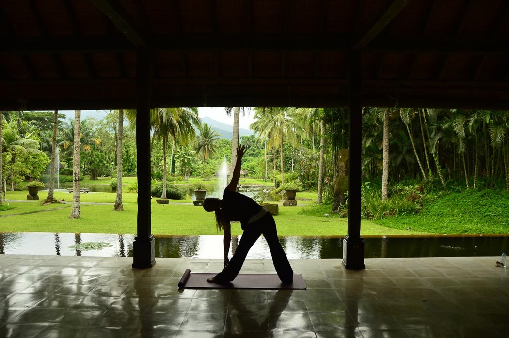 woman doing yoga in a pavillion with a view