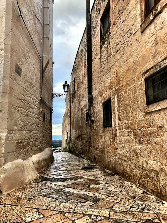 7 Best Places to Visit in Puglia (2022) 14 stone paved backstreet of Ostuni