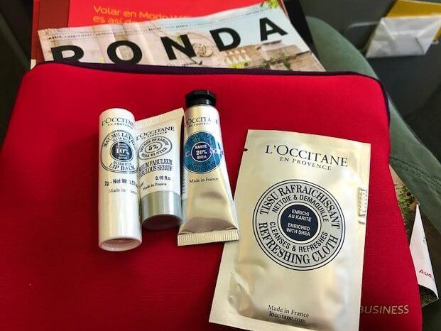 red toiletries bag for iberia airlines business class with L'Occitane products