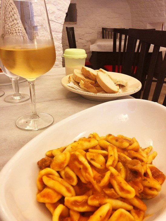 7 Best Places to Visit in Puglia (2022) 5 pasta and glass of wine