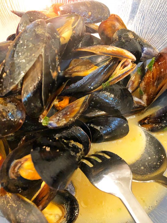 7 Best Places to Visit in Puglia (2022) 24 mussels on a plate with sauce in puglia