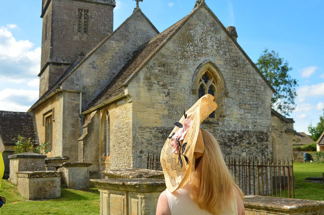woman from behind in hat with church